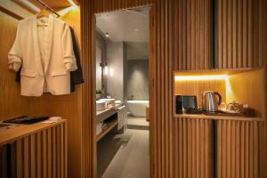 a bathroom with a white suit hanging on a wall at Only YOU Hotel Málaga in Málaga