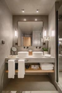 a bathroom with two sinks and a large mirror at Only YOU Hotel Málaga in Málaga