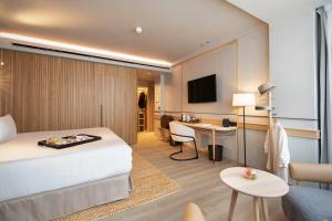 a hotel room with a bed and a desk at Only YOU Hotel Málaga in Málaga