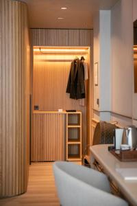 a room with a closet with a coat hanging on a door at Only YOU Hotel Málaga in Málaga