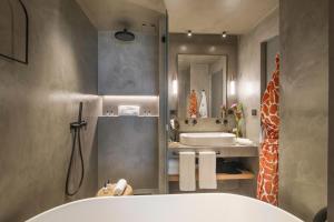 a bathroom with a tub and a sink and a giraffe at Only YOU Hotel Málaga in Málaga