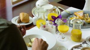 a table with a plate of food and glasses of orange juice at Crowne Plaza Bratislava, an IHG Hotel in Bratislava