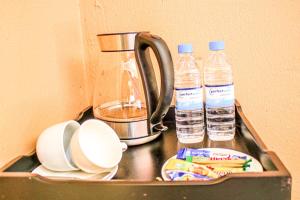 a kitchen sink with two bottles of water on it at Thavhani Guest House in Thohoyandou
