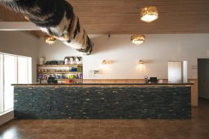 a lobby with a bar with animals hanging from the ceiling at Hótel Dyrhólaey in Vík