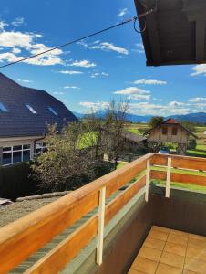 a view from the balcony of a house with a wooden railing at Apartma AJJA in Šenčur