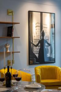 a dining room with yellow chairs and a picture on the wall at LUX Golden Apartment Praga Kępna by Renters Prestige in Warsaw