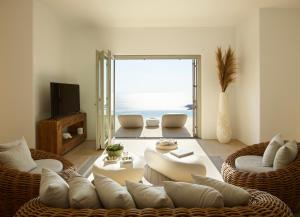 a living room with a view of the ocean at Absolute Paradise Villa Tourlos in Mikonos