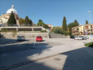 a parking lot with cars parked in it at Pensione Delfino Azzurro in Loreto