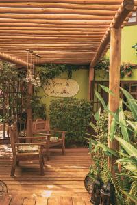 a wooden patio with two benches and a table at Beco Pousada Boutique in Fernando de Noronha