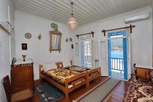 a bedroom with a bed in a room with a window at Skopelos house in Castle in Panormos Skopelos