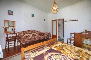 a living room with a couch and a table at Skopelos house in Castle in Panormos Skopelos +10 photos