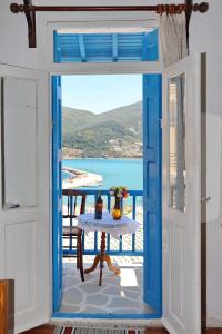 an open door with a table and a view of the ocean at Skopelos house in Castle in Panormos Skopelos