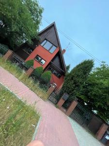 a red house on the side of a road at Dom blisko centrum in Kielce