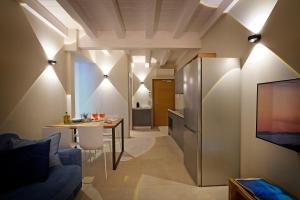 a kitchen and a living room with a couch and a table at Lamasu RioVerde - Lago di Garda in San Felice del Benaco