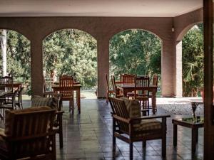 an empty restaurant with tables and chairs in a pavilion at Linvale Country Lodge in Hazyview