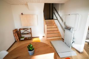 a room with a table and a refrigerator and stairs at LVM tūrisma un atpūtas centrs "Spāre" in Spāre