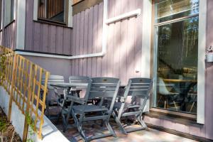 a table and chairs sitting on the side of a building at LVM tūrisma un atpūtas centrs "Spāre" in Spāre
