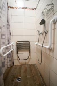 a shower in a bathroom with a wooden floor at LVM tūrisma un atpūtas centrs "Spāre" in Spāre