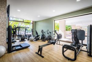 a gym with a lot of treadmills and exercise bikes at Barceló Marbella in Marbella