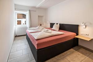 1 dormitorio con 1 cama con sábanas de color naranja y blanco en Appartement Sarah, en Sankt Martin