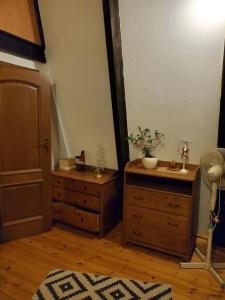 a bedroom with a dresser and a chest of drawers at Dom blisko centrum in Kielce
