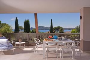 a table and chairs on a balcony with a view at Lamasu RioVerde - Lago di Garda in San Felice del Benaco