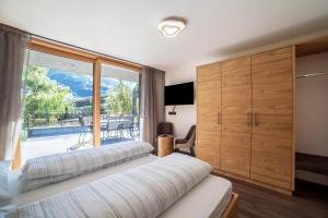 a bedroom with two beds and a large window at Chalet Riad in Saltusio