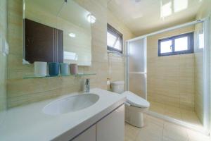 a bathroom with a sink and a toilet at Rice mansion in Wujie