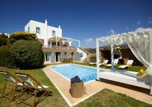 a villa with a swimming pool and a house at Heliades Villas in Gavrio