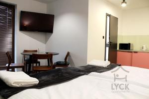 Łóżko lub łóżka w pokoju w obiekcie Lyck Apartamenty