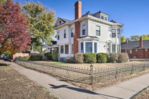 a white house with a fence in front of it at Classic Cañon City Getaway - 13 Mi to Royal Gorge! in Canon City