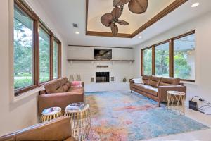 a living room with couches and a fireplace at Mid-Century Dream Home Less Than Half-Mile to Beach! in Ocean Springs