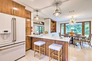 a kitchen and dining room with a dining table at Mid-Century Dream Home Less Than Half-Mile to Beach! in Ocean Springs
