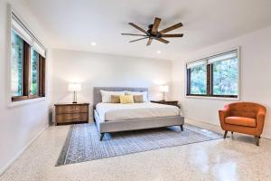 a bedroom with a bed and a ceiling fan at Mid-Century Dream Home Less Than Half-Mile to Beach! in Ocean Springs +37 photos