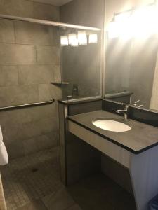 
a bathroom with a sink and a mirror at Beachside Motel - Amelia Island in Amelia Island
