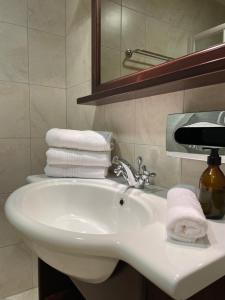 a bathroom with a white sink with towels on it at International House Sölden in Sölden