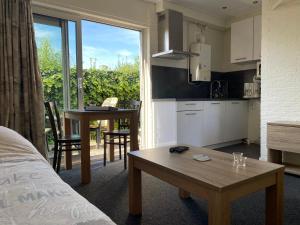 a kitchen and a living room with a table in a room at VVP Verhuur Vinkeveen in Vinkeveen