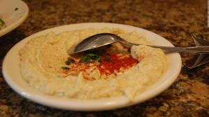 a bowl of food with a spoon on a table at HOTEL HAIFA in Varanasi