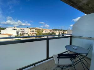 a balcony with a table and two chairs on it at Samsara Beach in Port d'Alcudia
