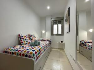 a bedroom with two beds with polka dots at Samsara Beach in Port d'Alcudia