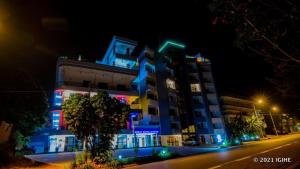 a building with blue and green lights on it at Great Hotel Kiyovu in Kigali