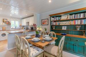 uma cozinha e sala de jantar com mesa e cadeiras em Mayfly Lodge em South Cerney