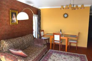 a living room with a couch and a dining room at Apartamento Romantico by the Ocean in Caniço