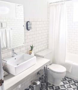 a white bathroom with a sink and a toilet at Amigo Motor Lodge in Salida