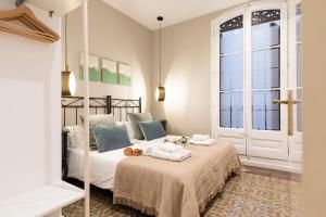 Posteľ alebo postele v izbe v ubytovaní Central Suites Barcelona