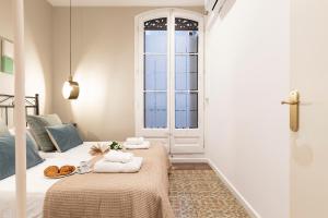 Posteľ alebo postele v izbe v ubytovaní Central Suites Barcelona