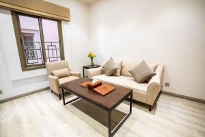 a living room with a couch and a table at Aram Hotel - AlMeshael Exit 18 in Riyadh