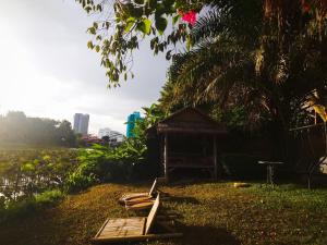 a gazebo and a bench in a yard at Mapping Hostel in Chiang Mai