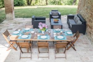 a wooden table and chairs on a patio at Villa Ca de Angeli - Tabiano Castle Country Villas in Salsomaggiore Terme