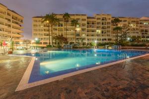 a large swimming pool in front of a building at 651 Bright establishment, heated pool and Wi Fi in Los Cristianos